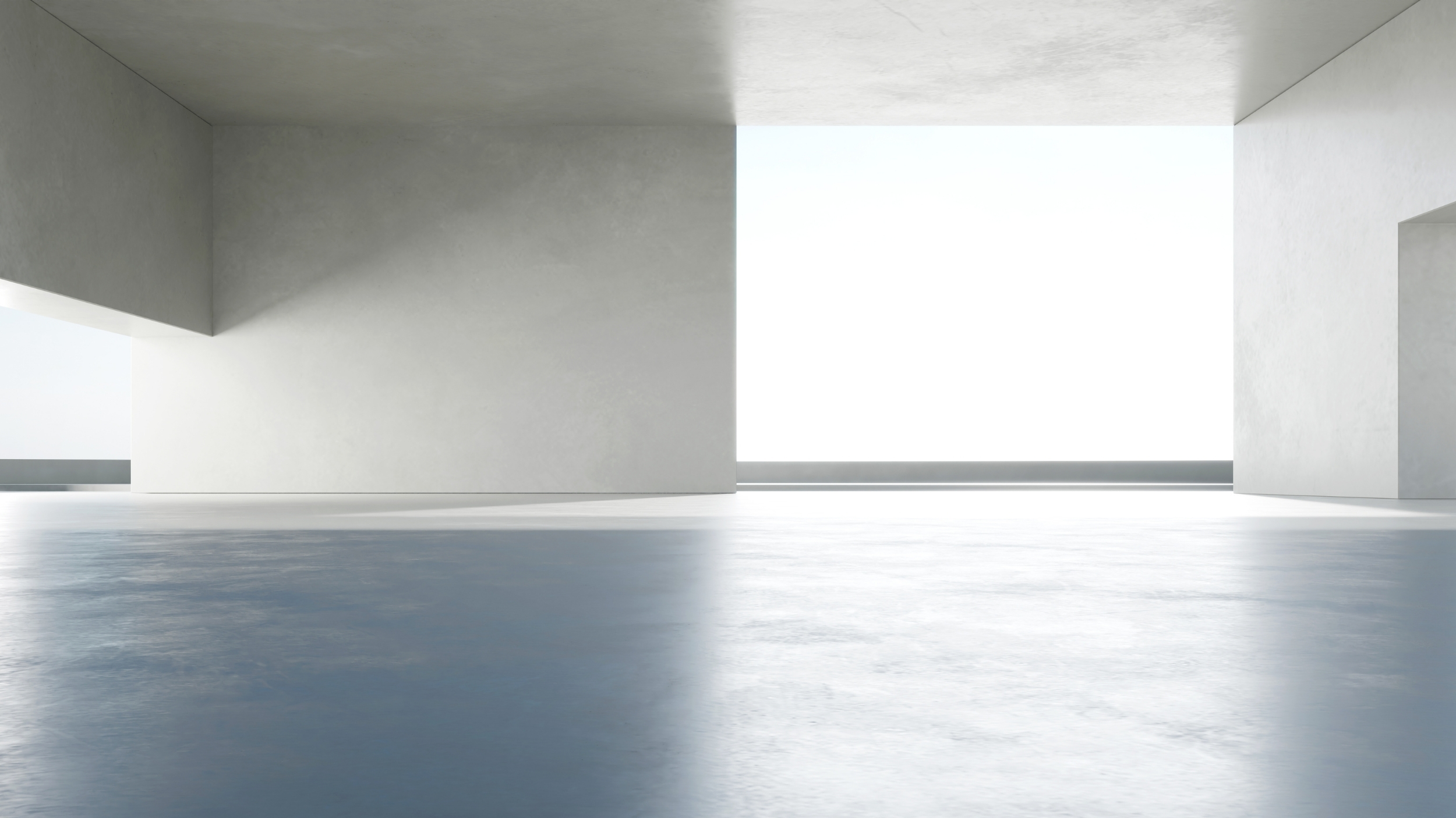 Interior minimalista com grandes janelas e luz natural em tons neutros. Espaço aberto moderno e elegante.